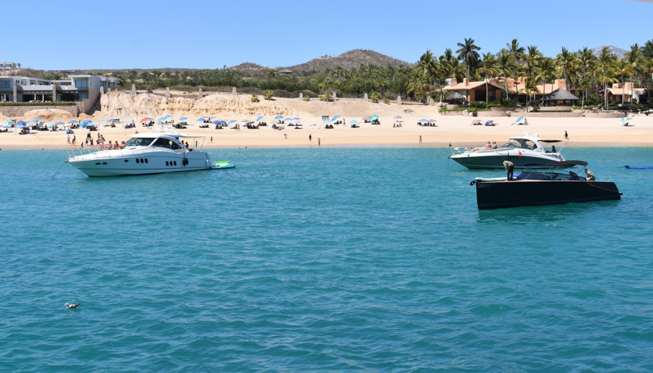 Luxury yacht anchored in the crystal-clear turquoise waters of Chileno Bay